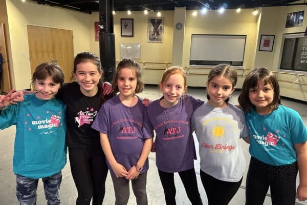 Dancers in matching all that jazz shirts
