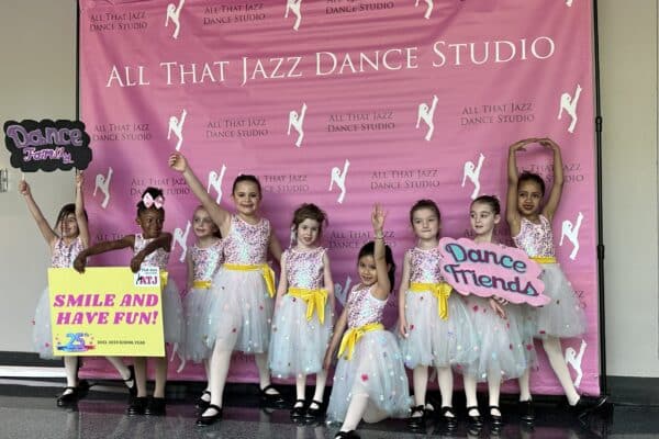 Dancers at All That Jazz recital with signs