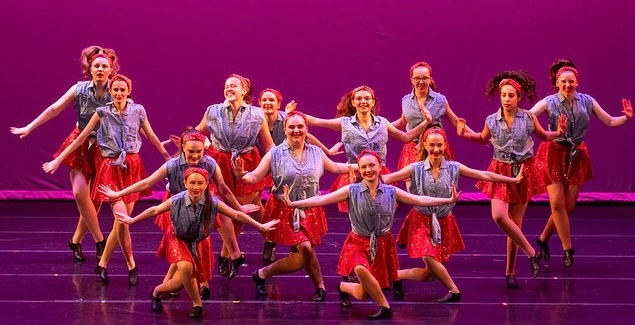 Energetic Group Dance in Denim and Red Costumes