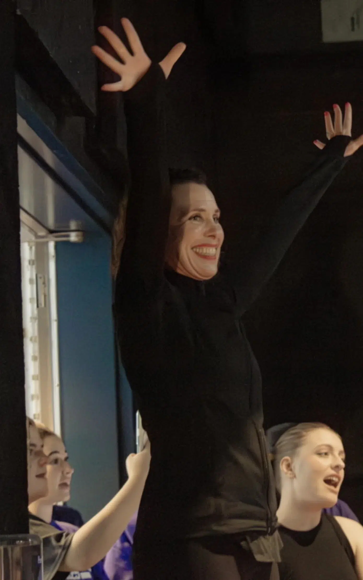 Dance Studio in Newton Testimonials Performer Celebrating on Stage with Raised Arms