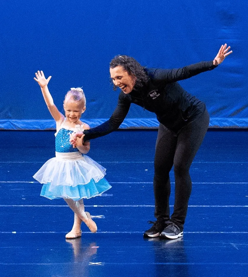 Young Dancer And Instructor Take A Bow On Stage