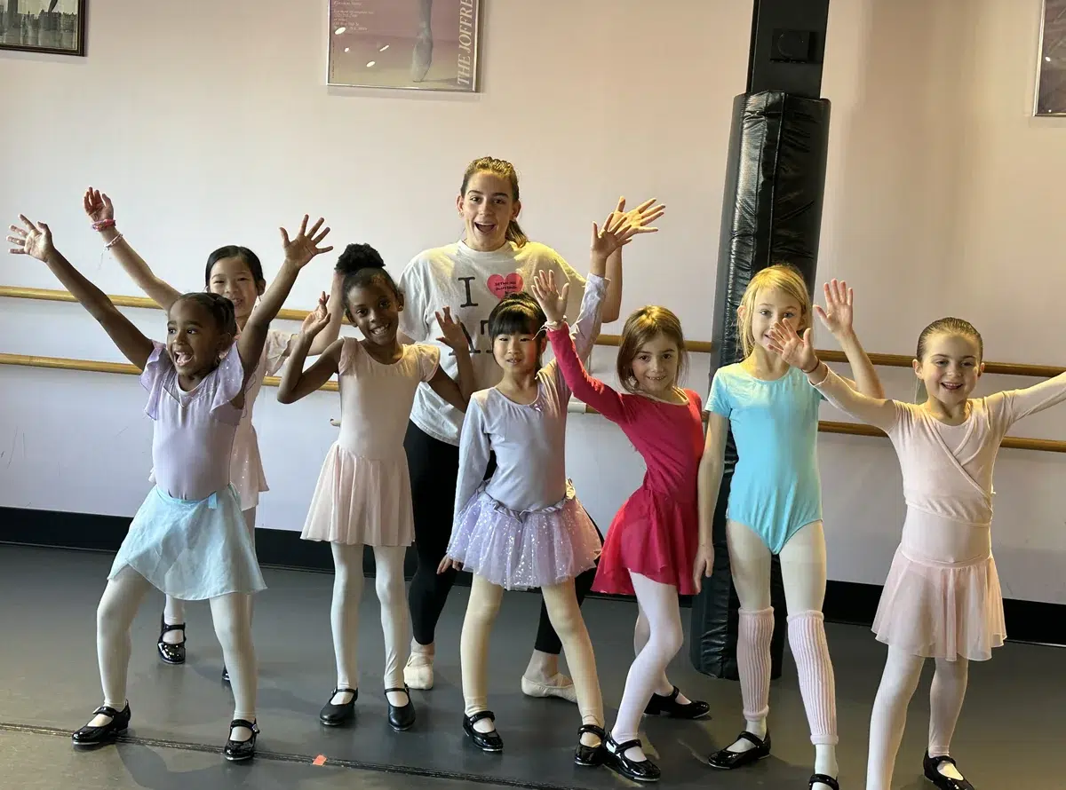 Ballet and tap combo class of young dancers in leotards and tap shoes