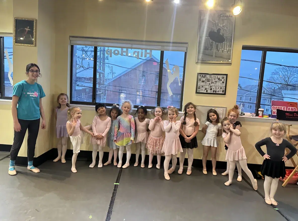 Fairytale Dance class of young ballet students lined up with their teacher in the studio