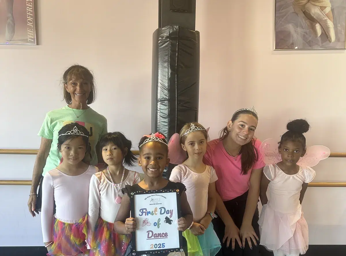 Tap dancers ages 7 to 11 at the barre during class